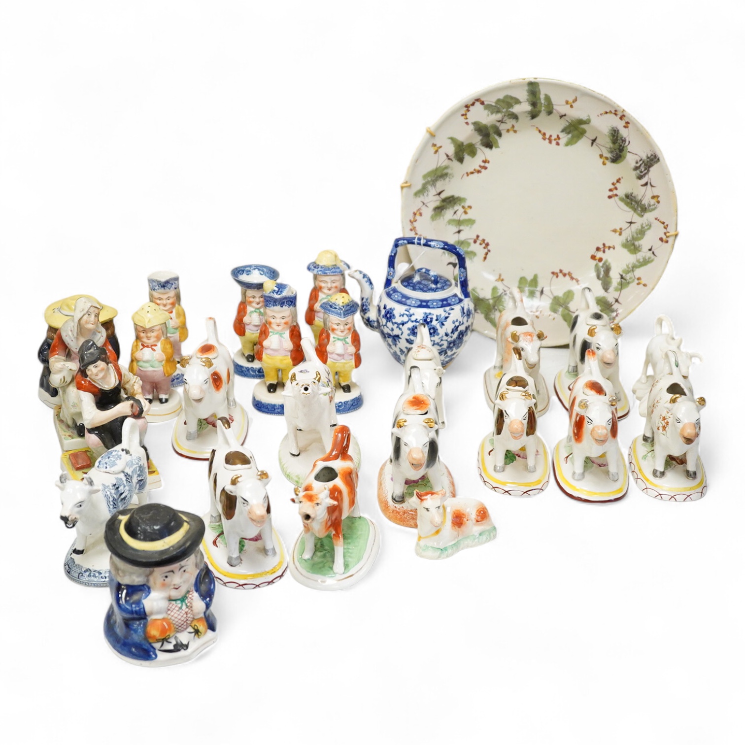 A large collection of English pottery cow creamers, Staffordshire figures and cruets a blue and white teapot and sponge ware dish-34cm diameter, (26)